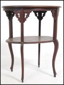 An Edwardian two tier side / occasional table being raised on serpentine shaped legs.
