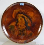 A Doulton Burslem Holbein ware charger depicting a Cavilier gentleman.