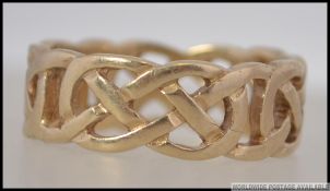 A 9ct hallmarked gold celtic knot twist band ring of good size and weight.