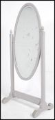 A large early 20th century shabby chic painted mahogany cheval mirror having a large oval mirror on