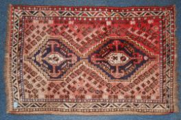 An early 20th century handwoven Islamic prayer rug with central mihrab and tassled ends.