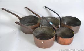 A set of five late 19th / early 20th century graduating copper saucepans.