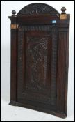 A Victorian large oak corner cabinet having carved details to the fielded panel.