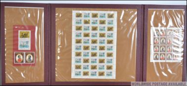 A small collection of unused sheets of Canadian postage stamps within a leather desk tidy / scribe.
