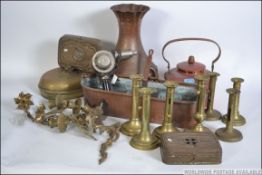 A good collection of 19th and 20th century brass wares to include candle sticks, planters,