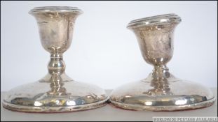 A near pair of silver hallmarked stub filled candlesticks having a Birmingham assay and dating to