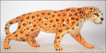 A Beswick china study of a crouching cheetah having printed Beswick marks to base.