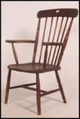 A late 19th century comb back / spindle Windsor armchair, on turned supports with stretchers,