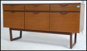 A 1970's Europa teak wood Danish influence sideboard raised on shaped supports with 3 drawers over