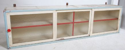 A vintage mid century painted pine shabby chic wall mounted cabinet in two tone colours with