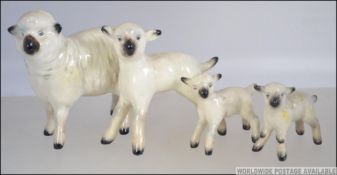 A group of 20th century Beswick sheep and lambs. To include Sheep 935, Lambs 936, 937 and 938.