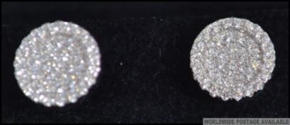 A contemporary pair of silver and cz cluster adorned ladies earrings. Complete in presentation box.