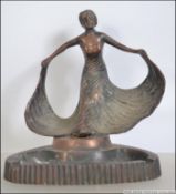A 1930's Art Deco copper ashtray with tray base and adorned with maiden to the back.