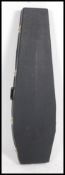 An unusual Warwick Casket coffin shaped guitar case with plush padded interior.