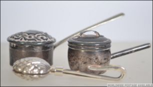 A pair of miniature silver hallmarked dolls house furniture lidded saucepans,