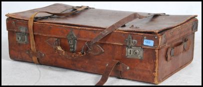 A good quality vintage tan leather suitcase retaining all the original leather straps.