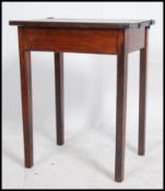An early 20th century oak school desk raised on squared legs with hinged worktop above.