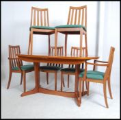 A G-Plan teak wood large extending dining table and chairs,