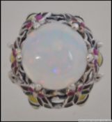 A 925 silver dress ring with a large central opalite and semi precious stone to the mount. Size N .