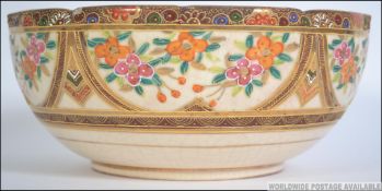 A 19th century good Japanese Satsuma ware fruit bowl with central vignette of Geisha's with gilded