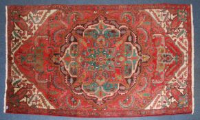 A beautiful 20th century Persian rug with stunning central diamond medallion centre with red ground