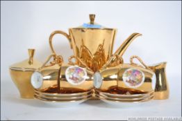 A Bavarian 20th century gilt lustre tea service to include the teapot, cups,
