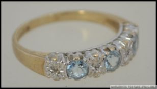 A 9ct gold and aquamarine 3 stone ring, the aquamarine believed stones being illusion set,