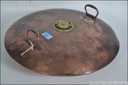 A large 19th century copper and brass bed warming pan of unusual roundel form with brass screw cap