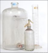 A vintage mid 20th century Pyrex flagon / Demi - John along with a vintage Pyrex scientific measure