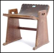 An early 20th century arts and crafts style priest stool- dressing table stool in an organic manner.