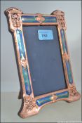An Art Nouveau copper and enamel painting photo - picture frame with easel wooden back. Measures 20.