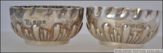 A pair of silver hallmarked table salts. Rococo form being hallmarked for Sheffield 1899.