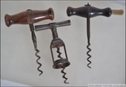 A collection of four vintage corkscrews dating back to the 19th century to include a vintage