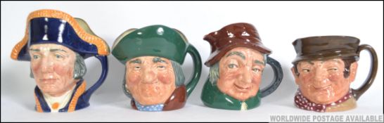 A collection of four large early ceramic Royal Doulton Toby Jug's.