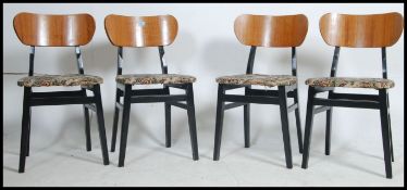 A set of 4 1960's believed G-Plan teak and ebonised butterfly shaped dining chairs with ebonised