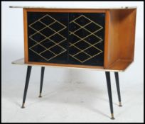 A 1950's mahogany retro vintage mid century side cabinet raised on dansette legs with black glass