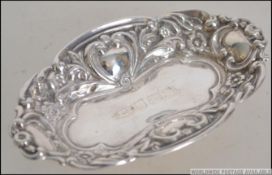 A small silver hallmarked pin tray of rococo form by Broadway and Co bearing hallmarks for