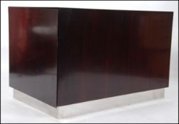 A 1970's Merrow Associates style rosewood and chrome plinth cabinet.