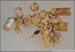 A 9ct gold hallmarked charm bracelet, with a collection of 16 9ct hallmarked gold charms,