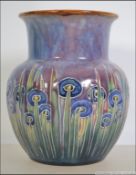 A Royal Doulton Lambeth Art Nouveau vase being stamped to the base with the 3670A impressed no.