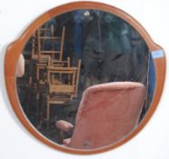 A retro atomic shaped teak wood frameless wall mirror.