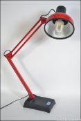 A late 20th century retro anglepoise two tone desk lamp in black and red having squared base with