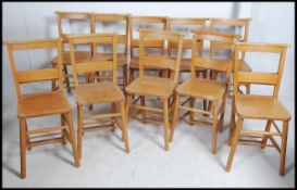 A Set of ten mid 20th century beech wood chapel chairs each with a fitted rear book trough.
