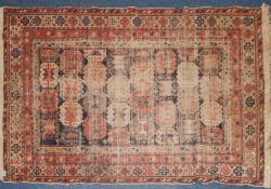 An early 20th century Persian Bokhara rug with multiple field of medallions having floral borders.