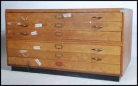A Vintage mid 20th Century light oak plan chest,
