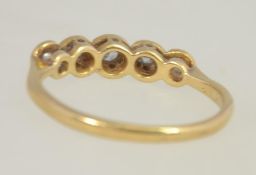 An 18ct gold and platinum ladies 5 stone diamond ring, the stones approx 20 pnts. Size M.