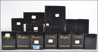A collection of boxed Woodford miniature brass clocks, all of varying style and designs,