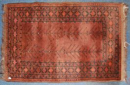 A late 19th / early 20th century Persian rug with tree of life centre on red ground with black