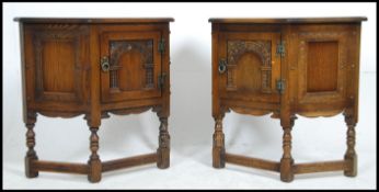 A pair of Ercol Old Colonial beech and elm side cabinets of angular half moon form raised on turned