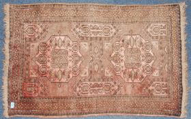 An early 20th century Persian rug with red ground,